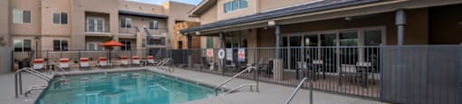 a swimming pool with a building in the background at Inspiration Apartments, Cottonwood, AZ, 86326