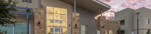 a building with a reflection of the sky in the window at Inspiration Apartments, Arizona