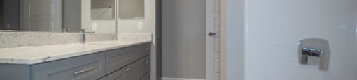 a bathroom with a shower and a sink and a mirror at Inspiration Apartments, Cottonwood, AZ