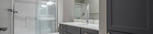 a bathroom with a shower and a sink and a mirror at Inspiration Apartments, Arizona