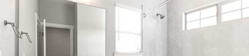 A white bathroom with a sink, toilet, and bathtub.