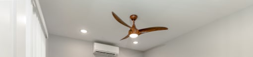 A room with a ceiling fan and an air conditioner unit.