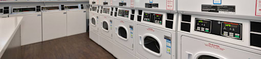 a row of washing machines in a laundry room