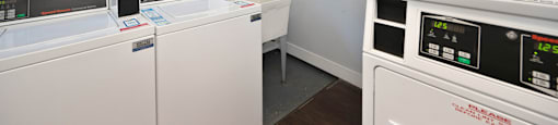 a laundry room with two washing machines and a sink