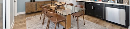 a kitchen and dining room with a table and chairs