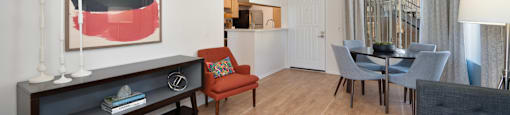 a living room and dining room with a table and chairs