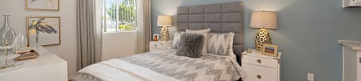 a bedroom with a bed and a dresser and a window