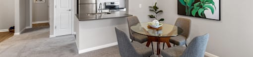 a dining room and kitchen with a table and chairs