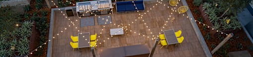 an aerial view of a patio with chairs and lights