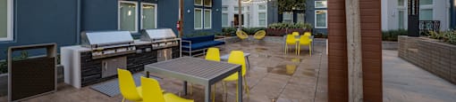 an outdoor patio with tables and chairs and string lights