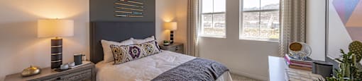 a bedroom with a large bed and a white table