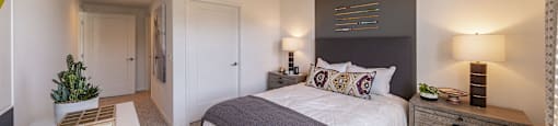 a bedroom with a large bed and a white table