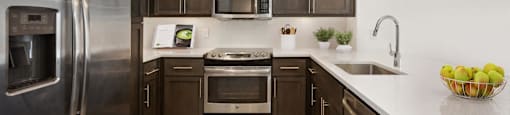 a kitchen with stainless steel appliances and wooden cabinets