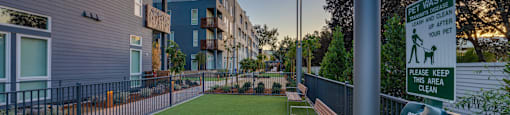 a dog park  with benches and a fence