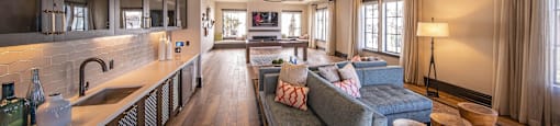 resident lounge with a kitchen and a blue couch