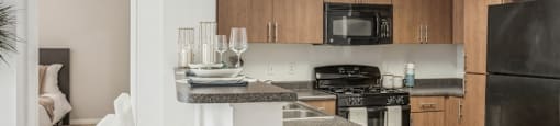 a kitchen with an island and a stove and a refrigerator