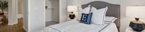 a bedroom with a large bed and a ceiling fan
