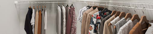 Clothes hanging on a rack in a room.