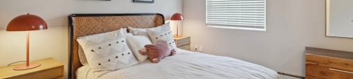 a bedroom with a bed and a dresser and a window