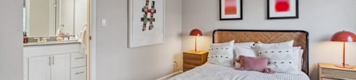 a bedroom with a bed and a bathroom with a sink