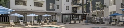 a swimming pool in front of an apartment building