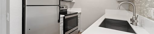 modern kitchen with stainless steel appliances at Pointe Luxe Apartment Homes, San Diego, CA, 92110