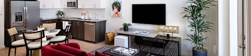 A modern living room with a red couch and a television.