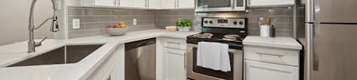 a kitchen with stainless steel appliances and white cabinets
