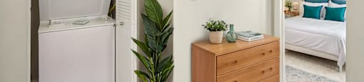 A small room with a white fridge, a wooden dresser, a potted plant, and a painting on the wall.