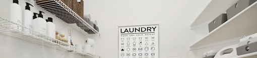 a laundry room with a washer and dryer and a calendar on the wall