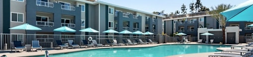lounge chairs at sparkling pool at Pointe Luxe Apartment Homes, San Diego, CA, 92110