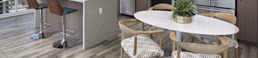 A modern kitchen with a dining table and chairs.