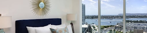 A bedroom with a large bed and a view of the city.