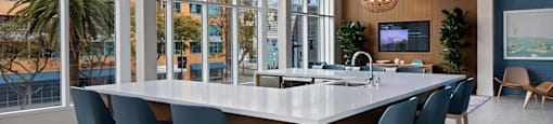A modern dining room with a long table and chairs.