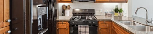 A kitchen with a black fridge and stove.
