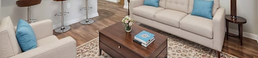 A living room with a white couch and a coffee table.