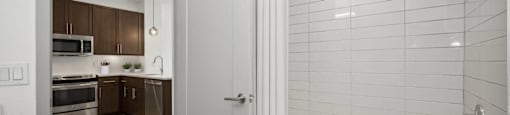 a bathroom with a shower and a sink in a room