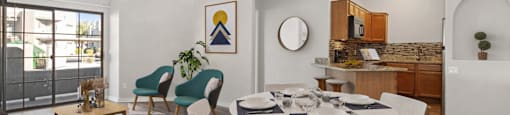 a living room with a dining room table and a kitchen