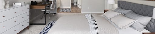 a bedroom with a bed and a desk with a chair