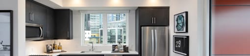 A modern kitchen with a large island and stools.