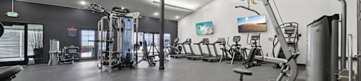 A gym with a variety of exercise equipment.