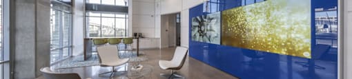 a room with a table and chairs and a large blue and yellow wall