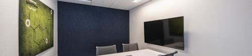 coworking space with a white table and chairs and a television