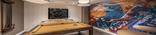 a game room with a pool table and a mural on the wall