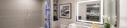 a bathroom with a shower toilet and sink