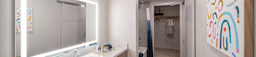 a bathroom with a large mirror and a sink