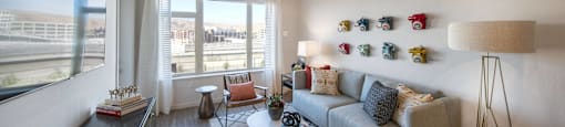 a living room with a couch and a table and a window