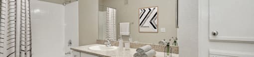 a bathroom with a large mirror and a shower and a toilet