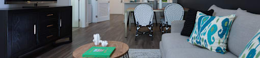 a living room with a couch and a table with chairs