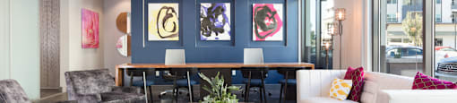 a living room with a blue accent wall and a wooden coffee table with a potted plant